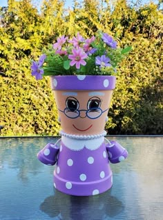 a potted plant with purple flowers in it