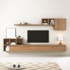 an entertainment center with shelves and a flat screen tv mounted on it's wall