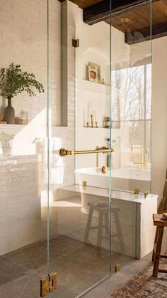 a bathroom with a bathtub, sink and stool next to a window in the room