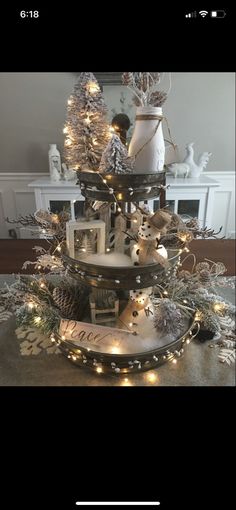 a three tiered christmas tree with lights on it