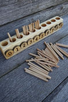 wooden pegs and numbers are arranged on a bench