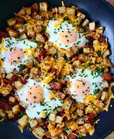 two fried eggs on top of potatoes in a skillet