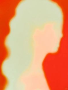 a blurry image of a person's head and neck with the shadow of a woman