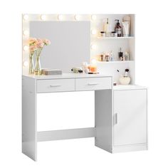 a white vanity with lights on it and flowers in the vase next to it,