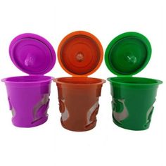 four different colored cups with lids on them