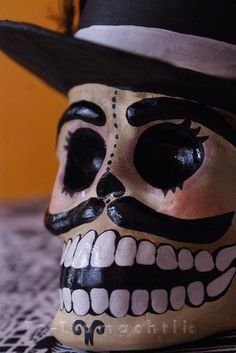 a close up of a skull with a hat on it's head wearing a top hat