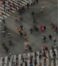 an aerial view of people walking across a crosswalk