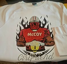 a white shirt with the words mccy on it and an image of a football player