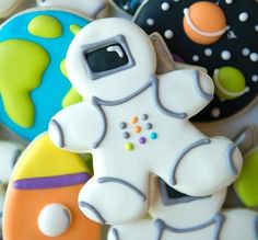 some cookies that are decorated to look like an astronaut's suit and space shuttle