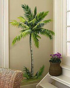 a potted palm tree sitting next to a window