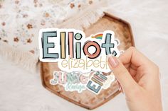 someone holding up a sticker with the word ellipot in japanese on it