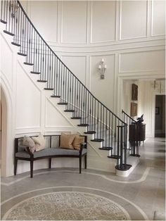 a large foyer with a staircase and two couches