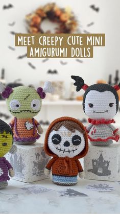 crocheted amigurmi dolls are displayed in front of a white table with black and orange decorations