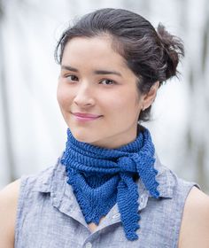 a woman wearing a blue knitted neck scarf