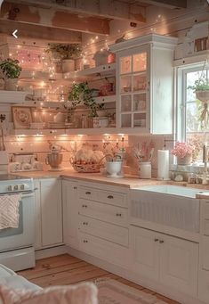 a kitchen filled with lots of white cabinets and counter top space next to a window