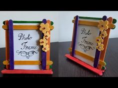 two small frames with flowers on them sitting on top of a wooden table next to each other