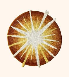 an orange slice with white stripes on it and some yellow sticks sticking out of it