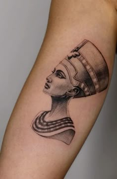 a woman's arm with an egyptian tattoo on it