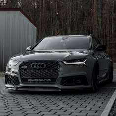 the front end of an audi car parked on a driveway