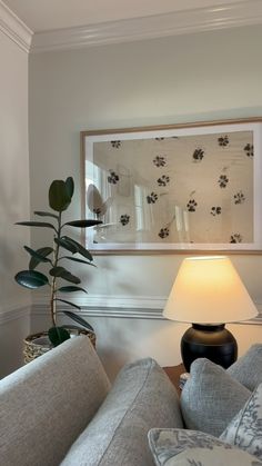 a living room scene with focus on the couch and lamp in the foreground,