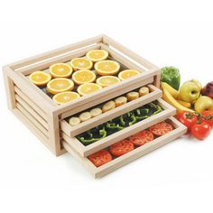 an assortment of fruits and vegetables are arranged in wooden trays on a white background