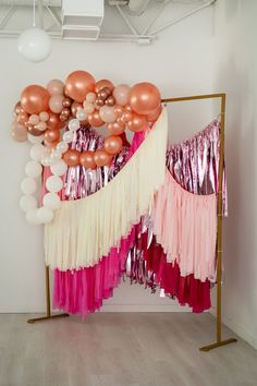 balloons and streamers are hanging on the wall