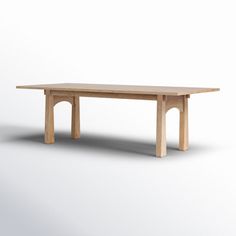 a wooden table sitting on top of a white floor