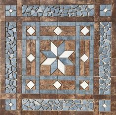 a tile floor with blue and white designs on it's sides, in the center