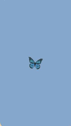 a blue butterfly is flying in the sky