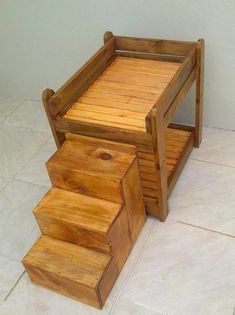 a wooden step stool sitting on top of a white tile floor