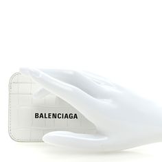 This is an authentic BALENCIAGA Shiny Calfskin Crocodile Embossed Logo Cash Card Casein Optic White. This stylish cardholder is crafted of white leather with Balenciaga lettering in black. The case has a primary compartment with card slots on both sides. Balenciaga Wallet, White Balenciaga, Card Holder Wallet, Embossed Logo, Emboss, White Leather, Card Slots, Calf Skin, Slots