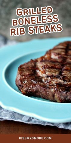 grilled boneless rib steaks on a blue plate with text overlay that reads grilled rib steaks rib steaks