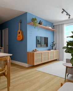 a living room filled with furniture and a guitar hanging on the wall next to a window