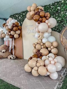 balloons are arranged in the shape of an animal and bear on display at a baby's first birthday party