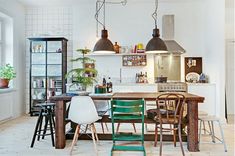 the kitchen table is surrounded by green chairs