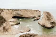 some rocks in the water and one is sticking out of it