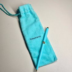 there is a pen in a blue bag on the table with it's sleeve open