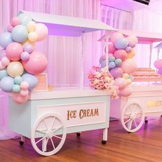 an ice cream cart is decorated with balloons