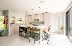 a kitchen with an island and bar stools