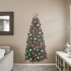 a decorated christmas tree in a living room with a mirror on the wall behind it