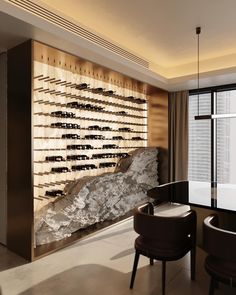 a dining room table with chairs and a wall mounted wine rack in the middle of it