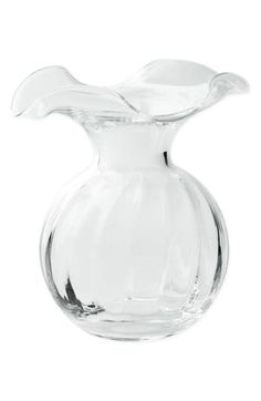 a clear glass vase sitting on top of a white table