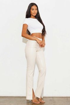 Step into a world of effortless chic with our Cream Vegan Leather Flare Pants. Imagine yourself strutting down city streets, turning heads with every step as the soft, buttery-smooth fabric hugs your curves in all the right places. These aren't just pants; they're a statement of your bold, fashion-forward mindset and your commitment to ethical choices. The luxurious cream hue elevates your entire wardrobe, offering a fresh alternative to basic black while maintaining versatility. As you slip int Cream Leather Pants Outfit, White Leather Pants, Women High Waist Pants, Pants Bootcut, Minimalistic Fashion, Curvy Swimwear, Leather Pants Women, Leather Pant, Bootcut Pants