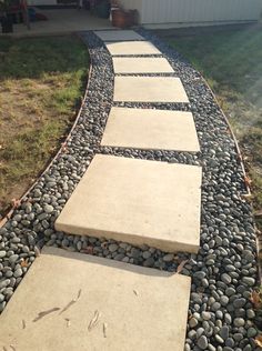 a walkway made out of stones and gravel