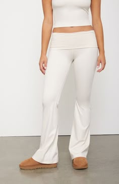 The PAC WHISPER Active Fold-Over Waistband Flare Yoga Pants from the PAC 1980 activewear collection make for the perfect piece for your next workout routine. These low-rise leggings have a fold-over waistband with flared leg openings and a tight figure-flattering fit. This piece is made with our PAC WHISPER™ fabric and has a buttery soft feel and quick-drying design that is perfect for working out or lounging around.Solid color leggings12" rise31.5" inseam22" leg openingButtery softQuick-drying4-way stretch24/7 comfortLow-riseFold-over waistbandFlared leg openingsTight fitHD silicone P logoFits true to size82% polyester, 18% spandexModel is wearing a size XSModel measurements: 5’7” height, 34” bust, 25” waist, 35.5” hipPAC WHISPER™: Buttery soft and quick-drying. Perfect from the studio to White Yoga Pants Outfit, Pacsun Clothes, Thrifted Tops, Pacsun Outfits, 13 Wishes, Foldover Leggings, Fold Over Leggings, Fold Over Yoga Pants, White Yoga Pants