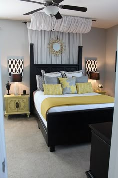 a bed with yellow and gray pillows in a bedroom