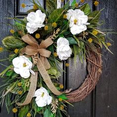 a wreath with white flowers and green leaves