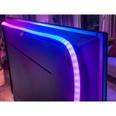 the back side of a computer monitor with blue and purple lights on it's sides