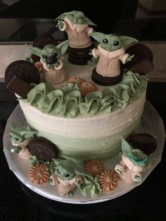 there is a cake decorated to look like baby yoda's