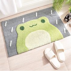 a pair of slippers sit on the floor next to a rug with a cartoon character